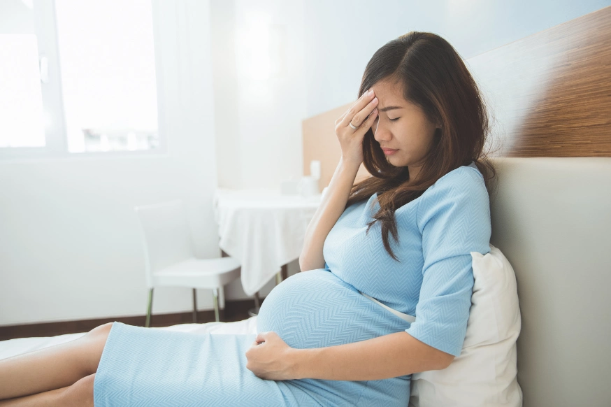 pregnant woman suffering from a headache