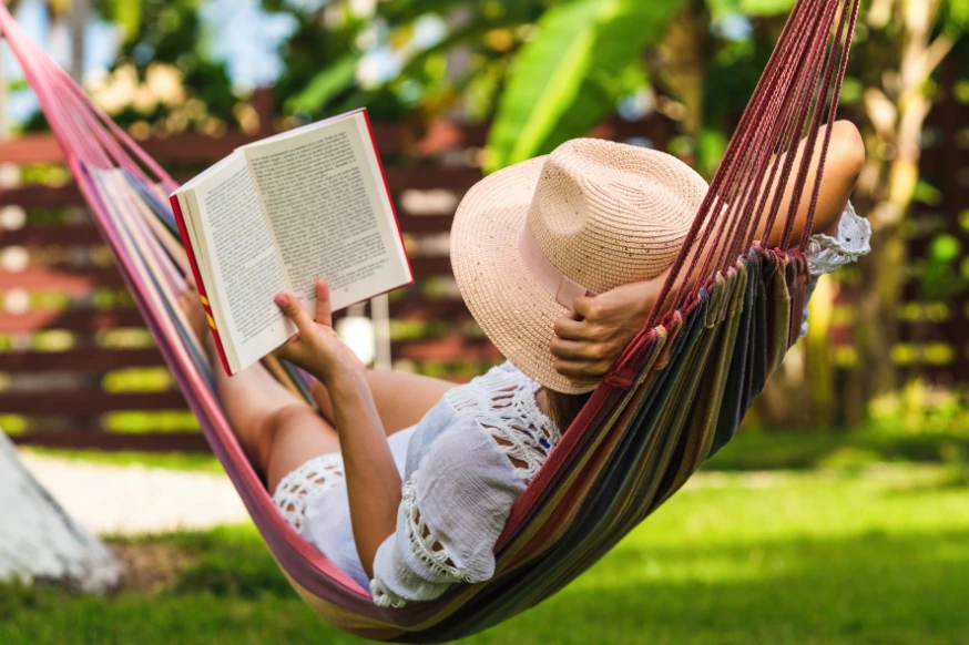 Woman reading in a hammock relaxing